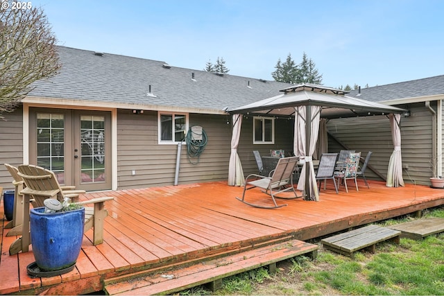 wooden terrace with outdoor dining area and a gazebo