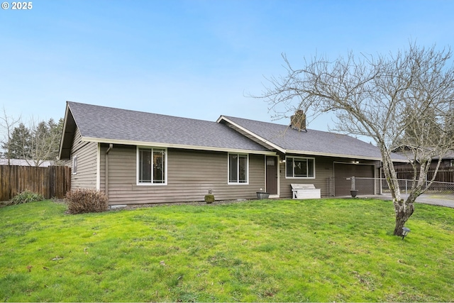 single story home with driveway, a shingled roof, an attached garage, fence, and a front yard