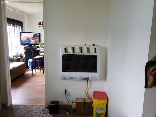 interior details featuring wood finished floors and heating unit