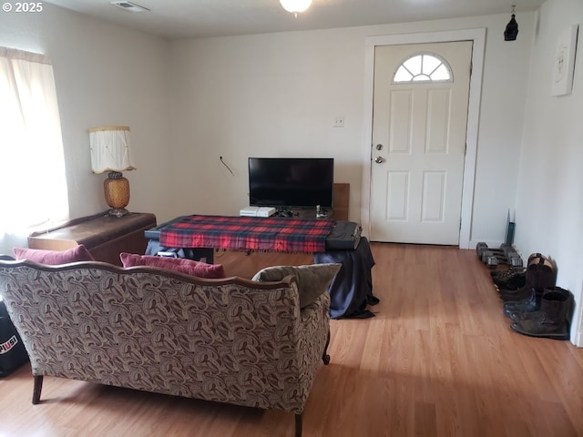 living area featuring wood finished floors and visible vents