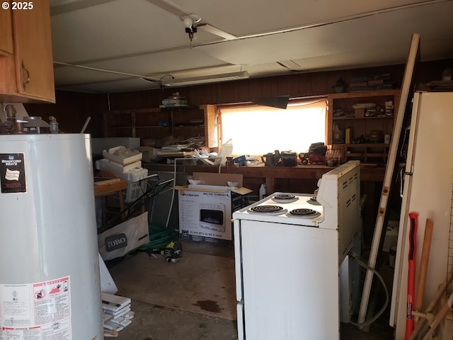kitchen featuring white range with electric cooktop, gas water heater, and concrete floors