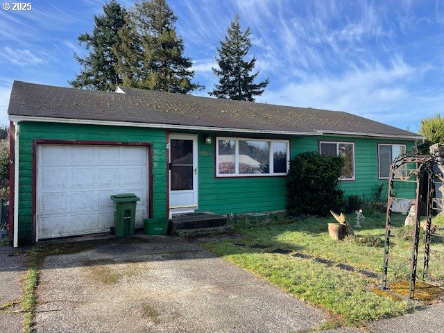 single story home with driveway, an attached garage, and entry steps