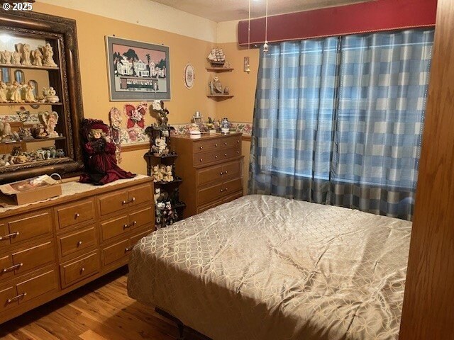 bedroom featuring wood finished floors