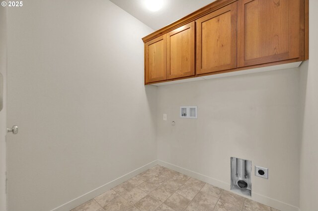 clothes washing area featuring cabinet space, washer hookup, gas dryer hookup, hookup for an electric dryer, and baseboards