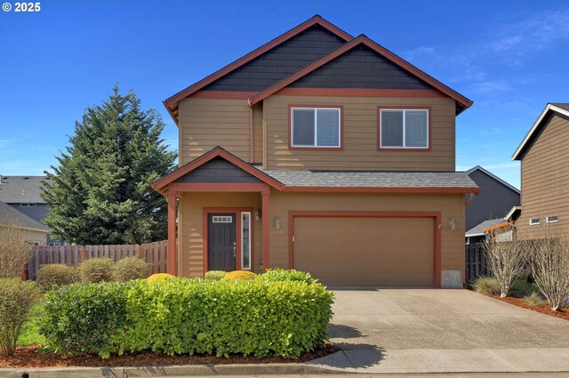 craftsman house featuring a front lawn, driveway, fence, and a garage