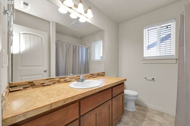 full bath featuring toilet, visible vents, baseboards, and vanity