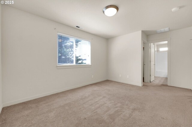unfurnished bedroom featuring carpet, visible vents, and baseboards