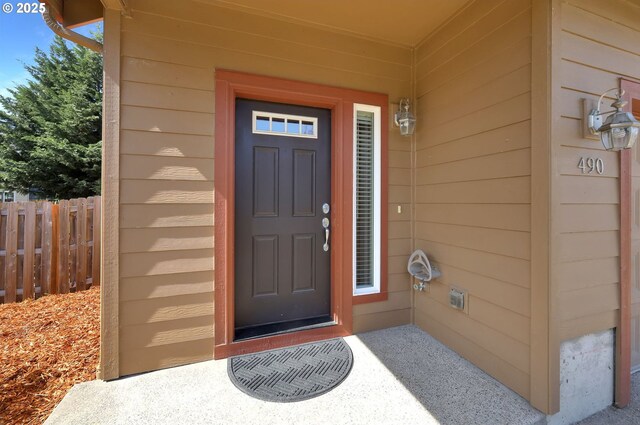entrance to property featuring fence