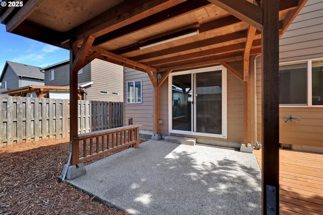 view of patio with fence and a wooden deck