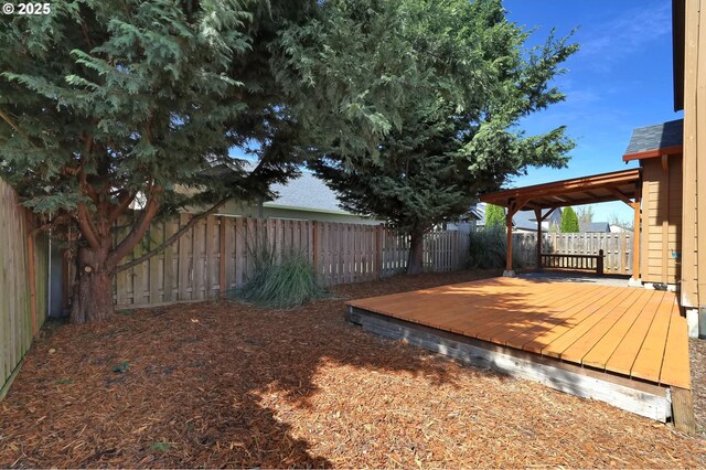 view of yard with a fenced backyard and a deck