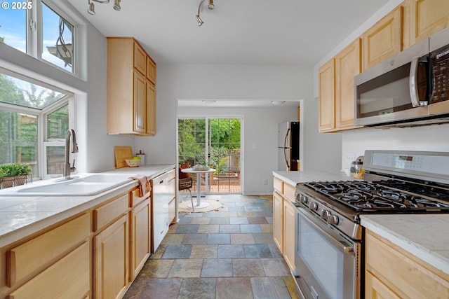 2951 NE 35th Ave, Portland, OR 97212 - kitchen with stainless steel appliances, light brown cabinets, and light countertops