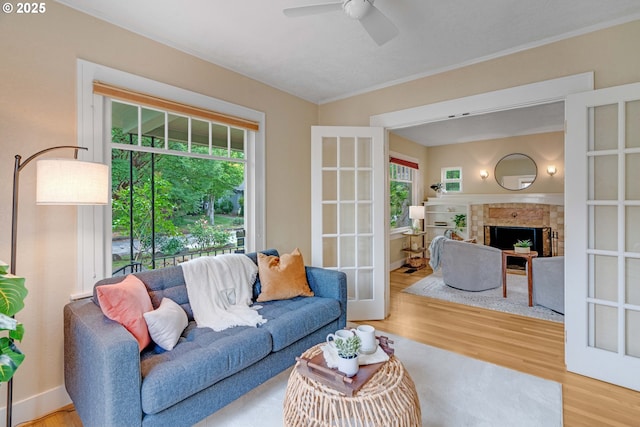 2951 NE 35th Ave, Portland, OR 97212 - living area featuring plenty of natural light, wood finished floors, ornamental molding, a ceiling fan, and a fireplace