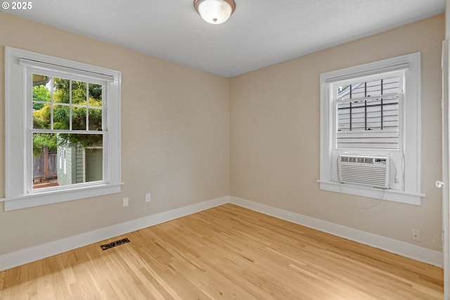 2951 NE 35th Ave, Portland, OR 97212 - empty room featuring wood finished floors and cooling unit