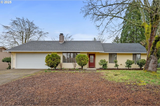 ranch-style home featuring roof with shingles, an attached garage, driveway, and a chimney