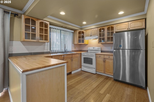 kitchen featuring light wood-type flooring, under cabinet range hood, white range with electric stovetop, freestanding refrigerator, and glass insert cabinets