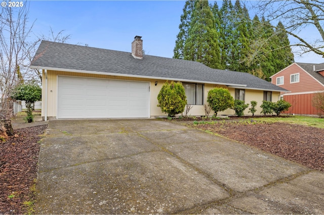 ranch-style home with driveway, an attached garage, a chimney, and a shingled roof