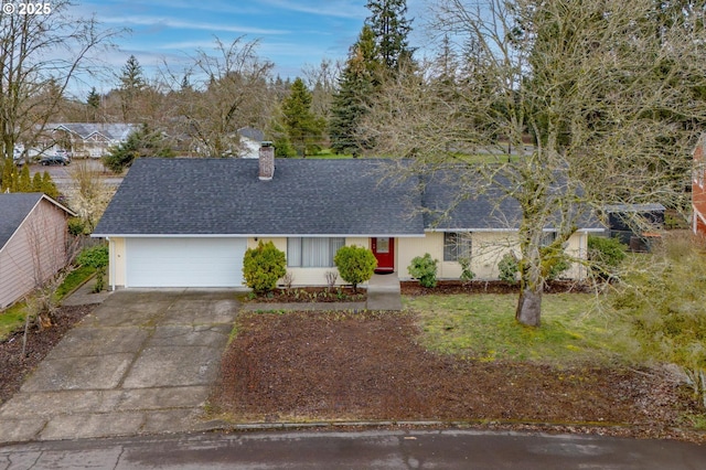 ranch-style house featuring a chimney, driveway, a shingled roof, and a garage