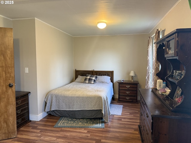 bedroom featuring dark hardwood / wood-style flooring and ornamental molding