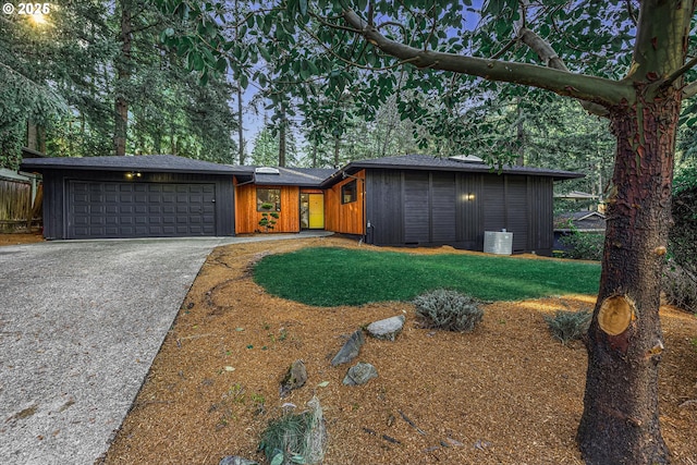 view of front of home with a front yard and a garage