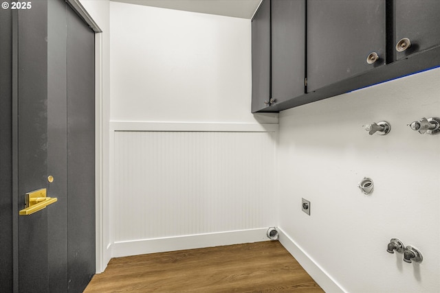 laundry area with cabinets, hardwood / wood-style flooring, electric dryer hookup, and hookup for a washing machine