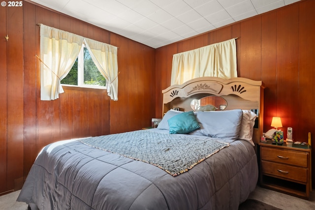 carpeted bedroom with wooden walls