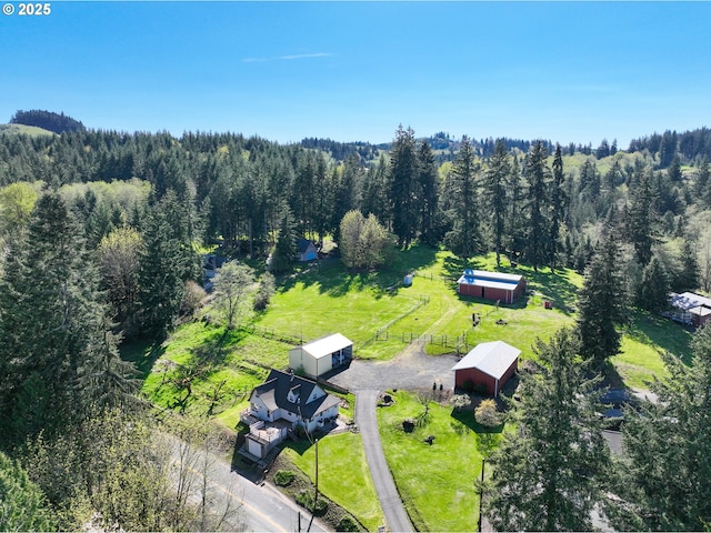 aerial view of property and surrounding area with a forest