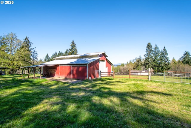 view of yard featuring a pole building, a garage, and an outdoor structure
