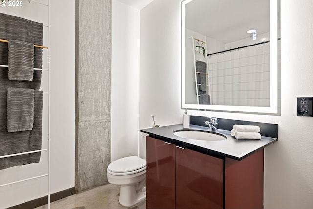 bathroom featuring toilet, tile patterned flooring, and vanity