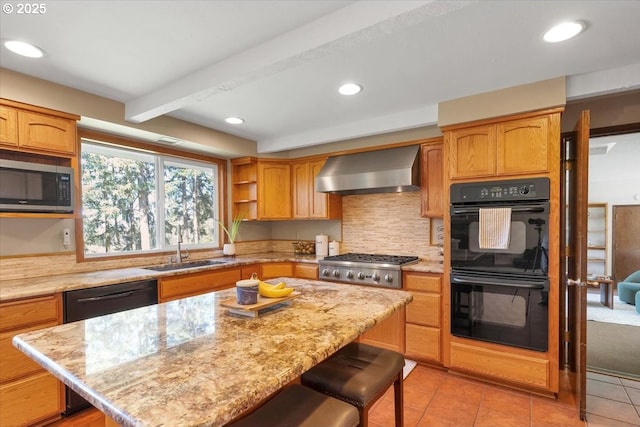 kitchen featuring a sink, wall chimney exhaust hood, a kitchen breakfast bar, light tile patterned floors, and black appliances