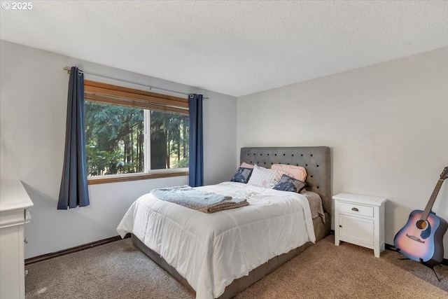 bedroom featuring carpet, baseboards, and a textured ceiling