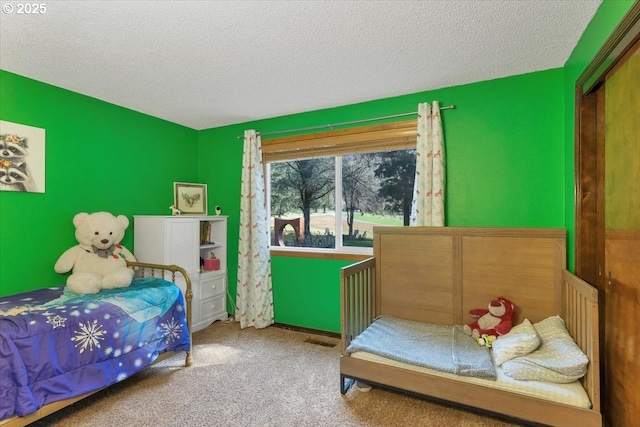 carpeted bedroom with a textured ceiling