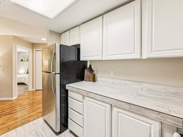 9908 SE Talbert St, Clackamas, OR 97015 - kitchen with freestanding refrigerator, white cabinets, light countertops, recessed lighting, and light wood-style floors