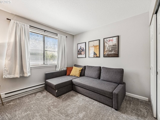 9908 SE Talbert St, Clackamas, OR 97015 - living area with a baseboard radiator, carpet flooring, and a textured ceiling