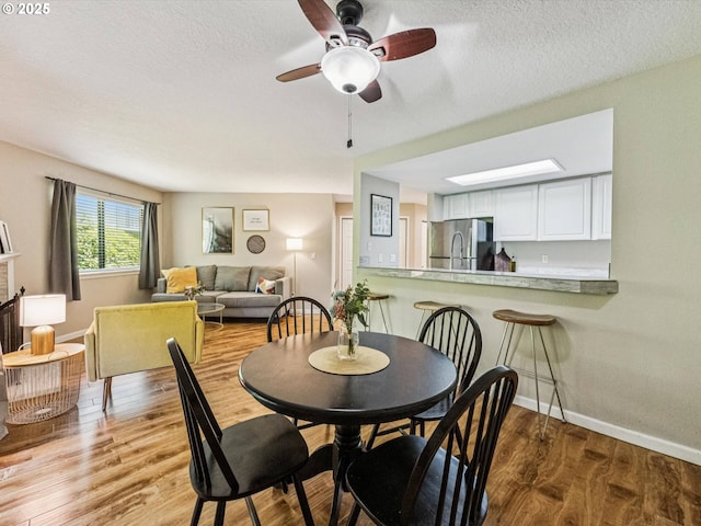 9908 SE Talbert St, Clackamas, OR 97015 - dining room featuring wood finished floors, ceiling fan, and a textured ceiling