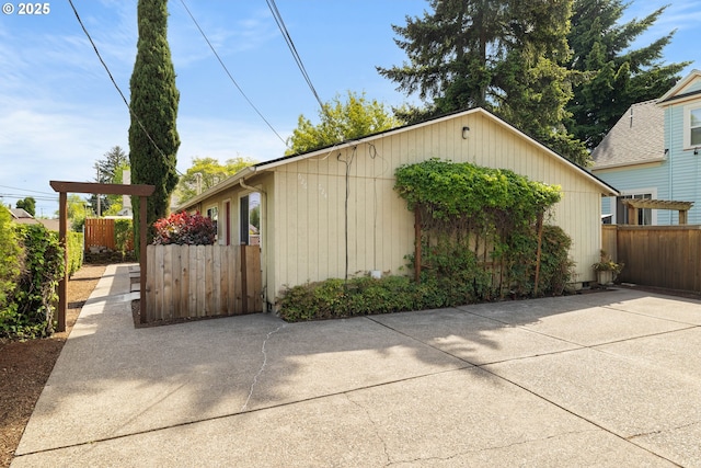 view of side of property featuring fence