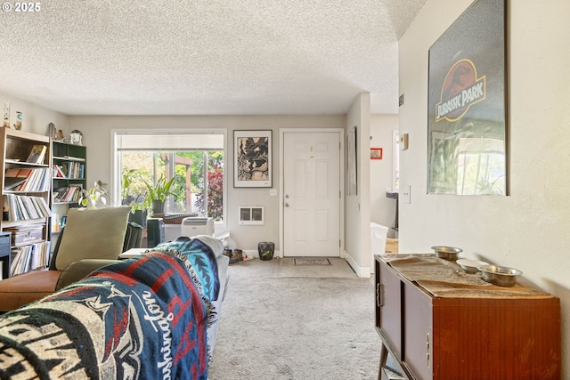 living area featuring carpet and a textured ceiling