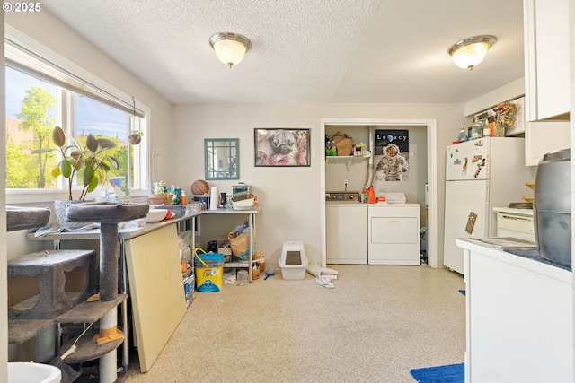 playroom with washing machine and dryer and a textured ceiling