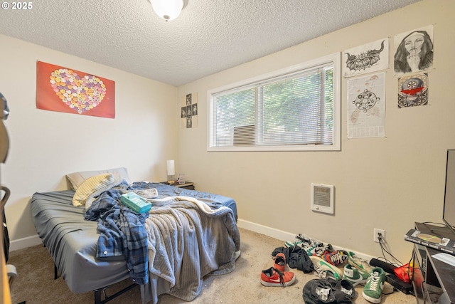 bedroom featuring a textured ceiling, carpet, baseboards, and heating unit