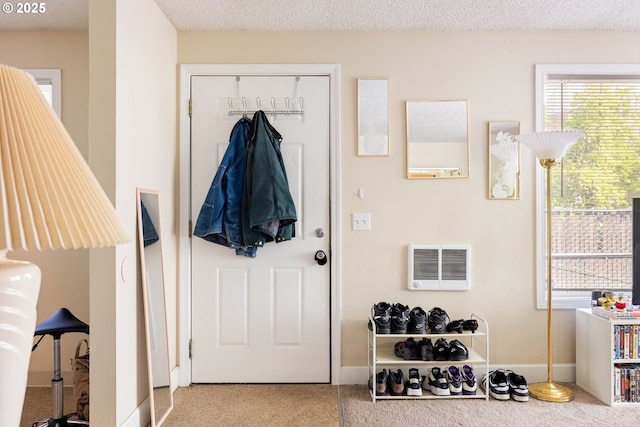 doorway to outside with carpet floors and baseboards