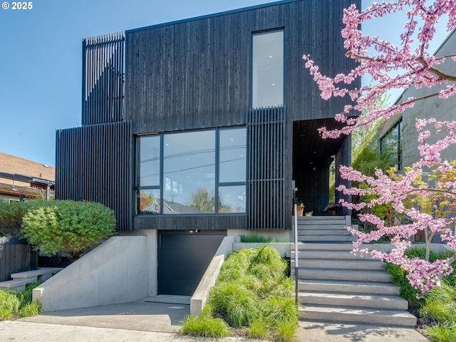 modern home with stairway and an attached garage
