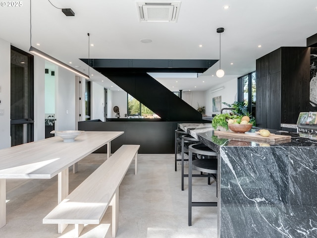 dining area with finished concrete floors and recessed lighting