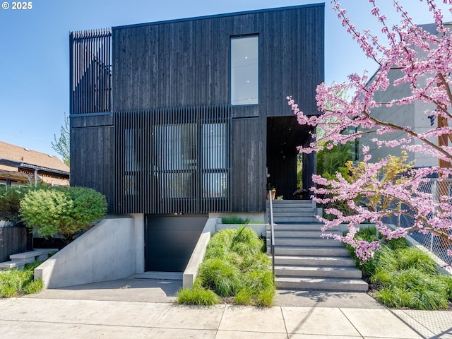 view of front of home featuring stairs and an attached garage