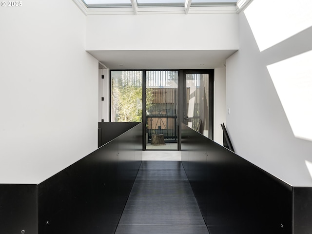 interior space with a high ceiling and a skylight