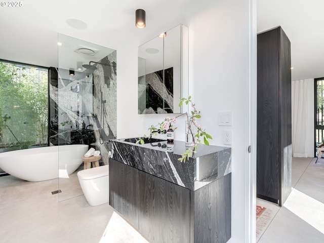 full bathroom featuring a soaking tub, vanity, a walk in shower, toilet, and finished concrete floors