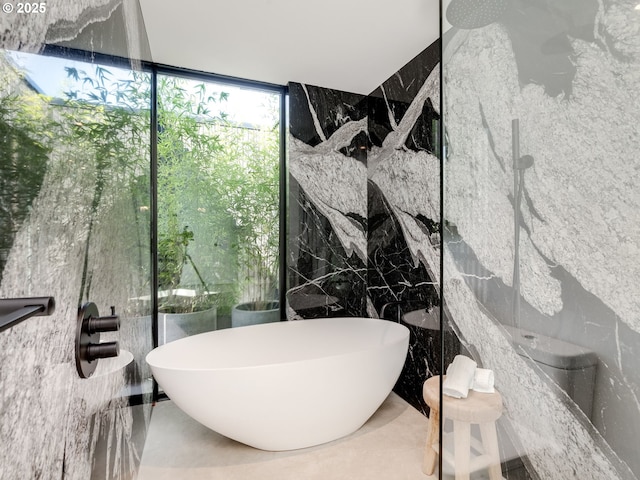 full bathroom with tile walls, a soaking tub, floor to ceiling windows, and a shower