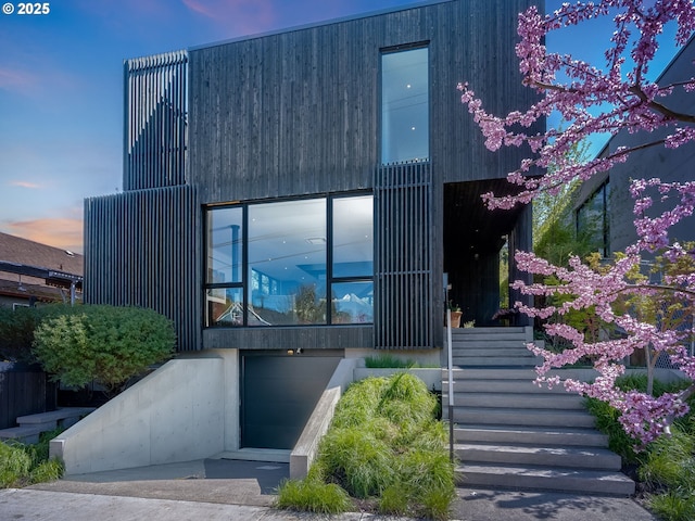 view of front facade featuring stairway and a garage