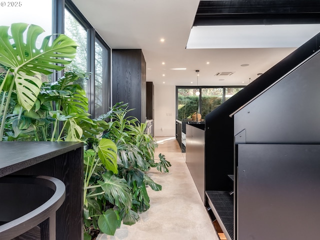 hall with recessed lighting and floor to ceiling windows