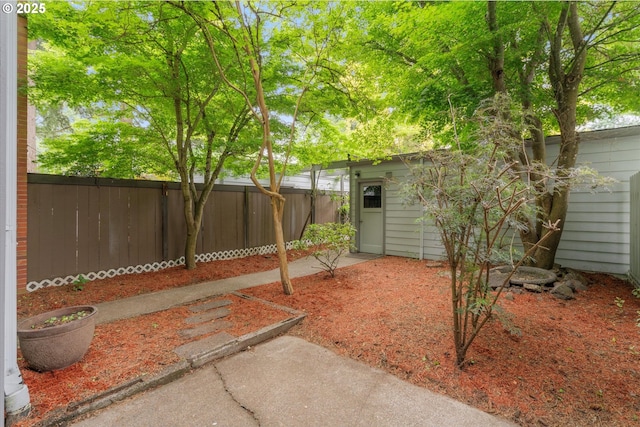 fenced backyard with an outdoor structure