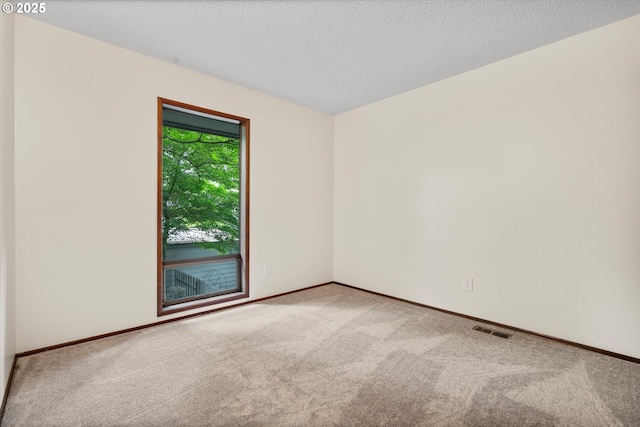 spare room with carpet floors and baseboards