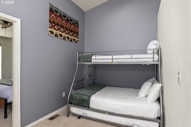 bedroom with baseboards, visible vents, and carpet